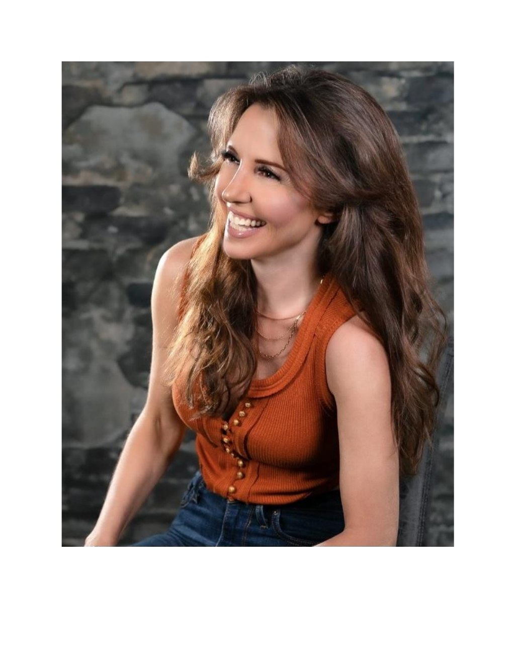 Amanda Kasmira &ldquo;Kazzy&rdquo; Cryer &mdash; portrait, smiling against a stone wall