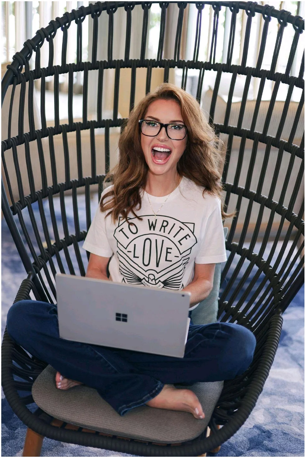 Amanda Kasmira &ldquo;Kazzy&rdquo; Cryer in egg chair with laptop — editorial portrait